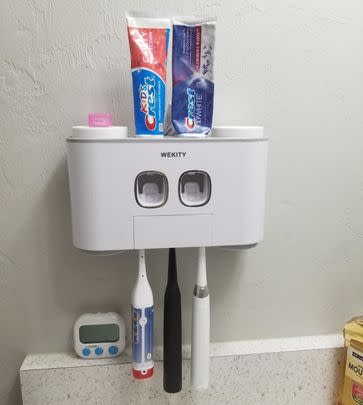 A toothbrush station to clear up your bathroom counter by hanging up to five toothbrushes and two toothpaste tubes in this wall-mounted gadget