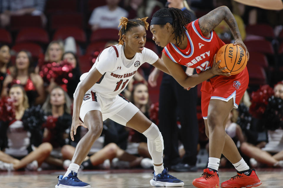 Liberty guard Dee Brown, right, protects the basketball from South Carolina guard Talaysia Cooper during the second half of an NCAA college basketball game in Columbia, S.C., Sunday, Dec. 11, 2022. South Carolina won 88-39. (AP Photo/Nell Redmond)