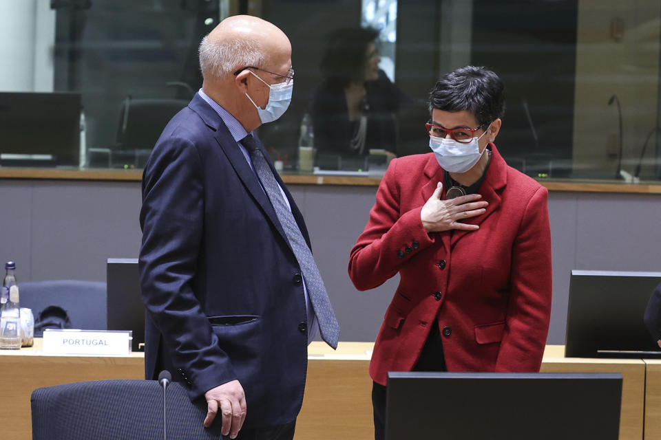 Spain's Foreign Minister Arancha Gonzalez Laya, right, speaks with her Portuguese counterpart Augusto Santos Silva during a European Foreign Affairs Ministers meeting at the European Council headquarters in Brussels, Monday, March 22, 2021. (Aris Oikonomou, Pool Photo via AP)