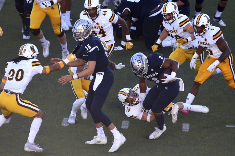 Nevada running back Jamaal Bell, (2) runs for a first down against Wyoming during the first half of an NCAA college football game on Saturday, Oct. 24, 2020, in Reno, Nev. (AP Photo/Lance Iversen)