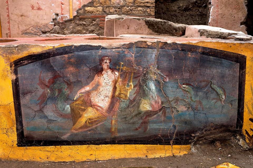 This picture released on December 26, 2020 by the Pompei Press Office shows a thermopolium, a sort of street "fast-food" counter in ancient Rome, that has been unearthed in Pompei, decorated with polychrome motifs and in an exceptional state of preservation