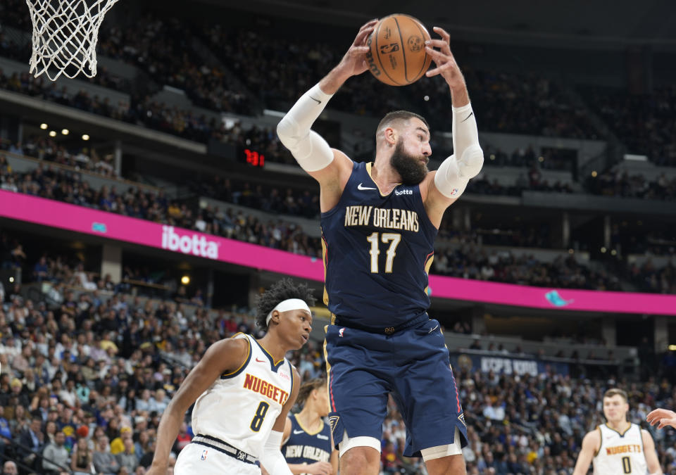 New Orleans Pelicans center Jonas Valanciunas (17) pulls in a rebound in front of Denver Nuggets forward Peyton Watson (8) in the first half of an NBA basketball game Monday, Nov. 6, 2023, in Denver. (AP Photo/David Zalubowski)