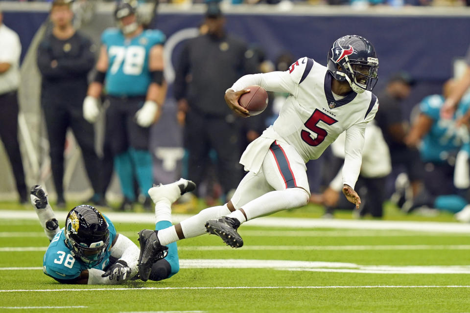 Houston Texans quarterback Tyrod Taylor (5) breaks away from Jacksonville Jaguars safety Andre Cisco (38) during the second half of an NFL football game Sunday, Sept. 12, 2021, in Houston. (AP Photo/Eric Christian Smith)