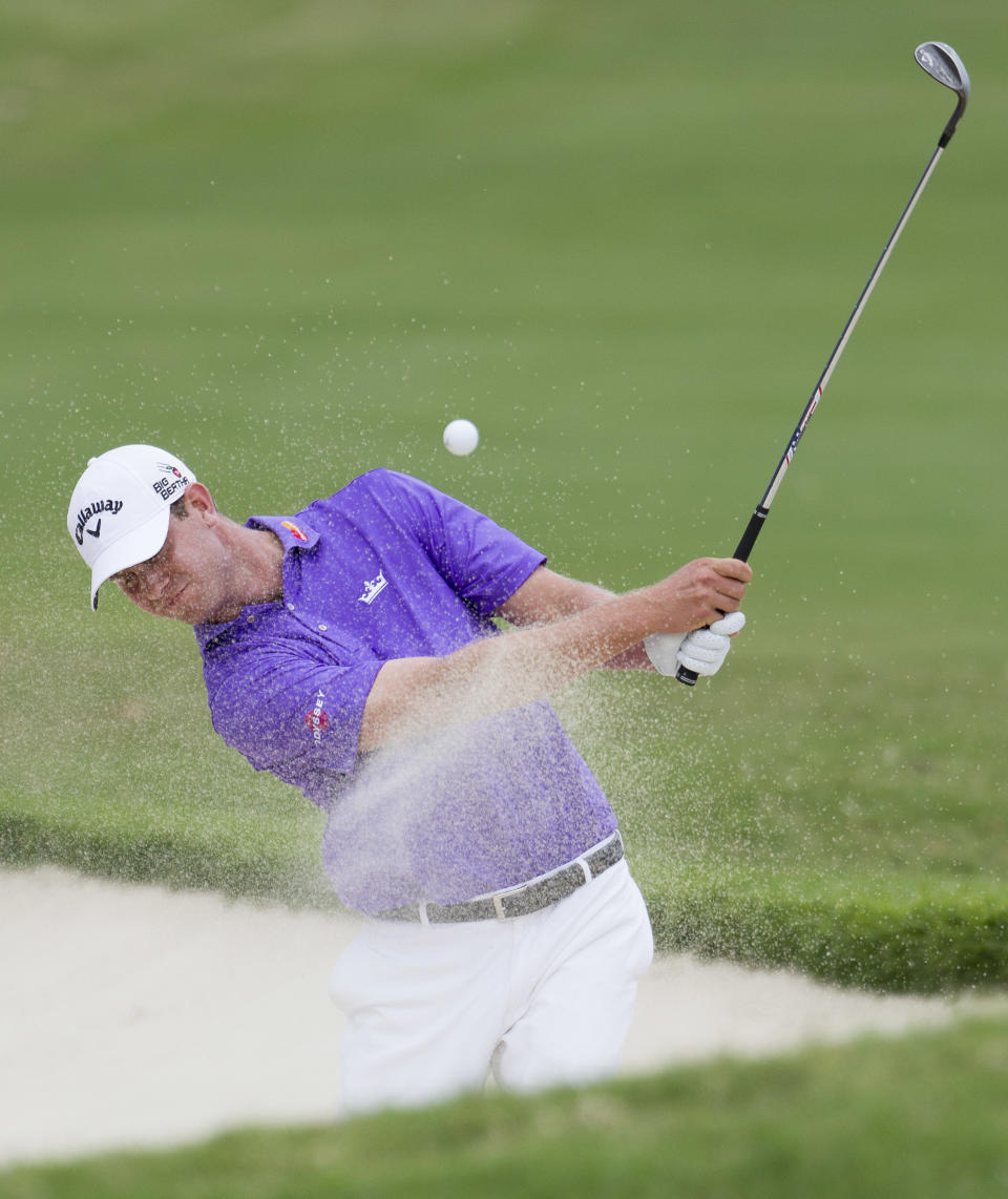 Harris English hits out of the sand trap and onto the 18th green during the third round of the Sony Open golf tournament at Waialae Country Club, Saturday, Jan. 11, 2014, in Honolulu. (AP Photo/Eugene Tanner)