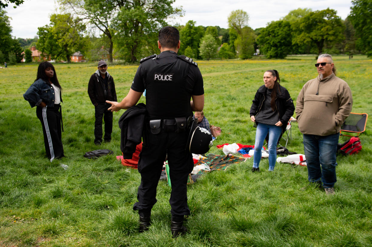 Police monitor a gathering of people at Highbury Park in Birmingham, after the introduction of measures to bring the country out of lockdown.
