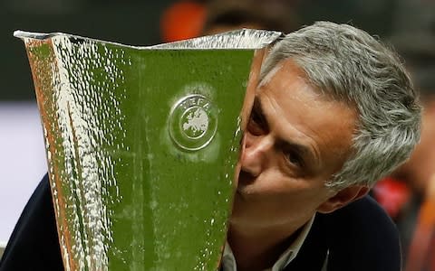 Jose Mourinho kisses the Europa League trophy - Credit: AFP