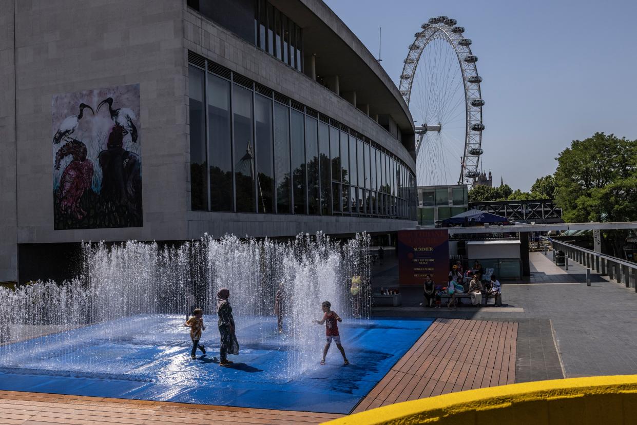 Kids cool themselves in a fountain outside the Queen Elizabeth Hall on the Southbank on July 19, 2022 in London, United Kingdom.