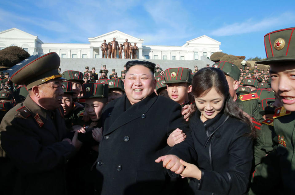 Pictured is Kim Jong-un and his wife Ri Sol-ju surrounded by North Korean military. 