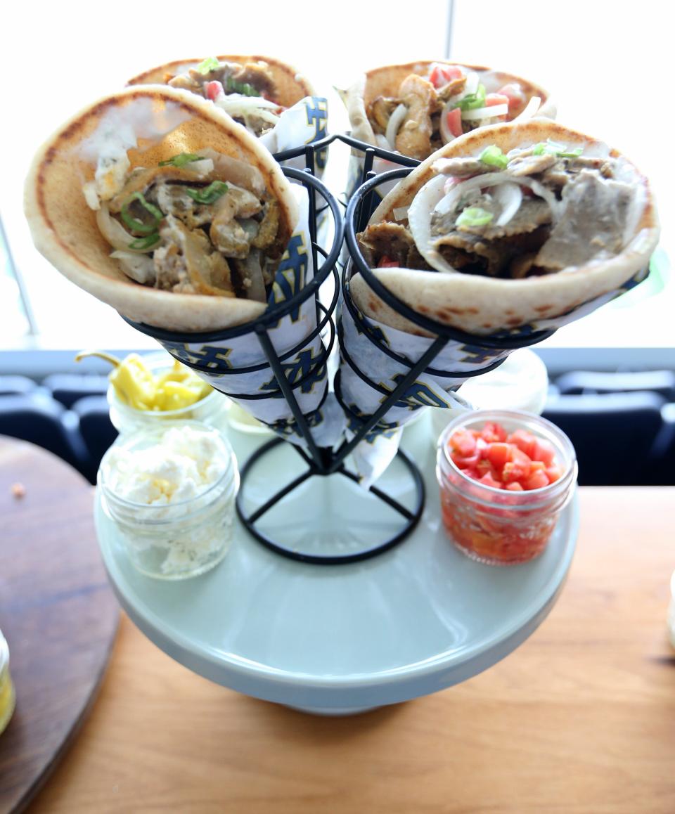 New for Notre Dame football fans this season is a chicken shawarma pita, at left, and Greek gyros at right. These and other new food items will join all-time favorites for fans this year at Notre Dame Stadium.