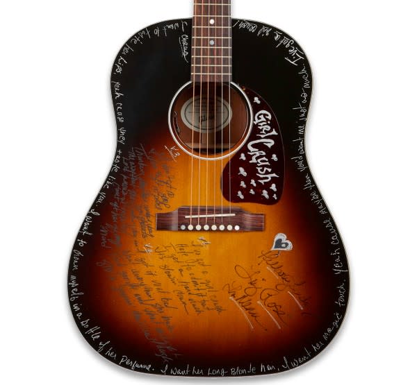 A “Girl Crush” guitar autographed by The Love Junkies — songwriters Hillary Lindsey, Liz Rose and Lori McKenna