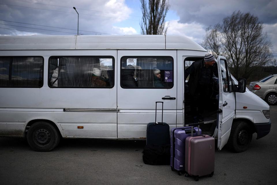 The driver of a minibus waits for Ukrainian refugees to board after crossing the Ukrainian-Moldovan border at the Palanca crossing in southeastern Moldova on April 12.