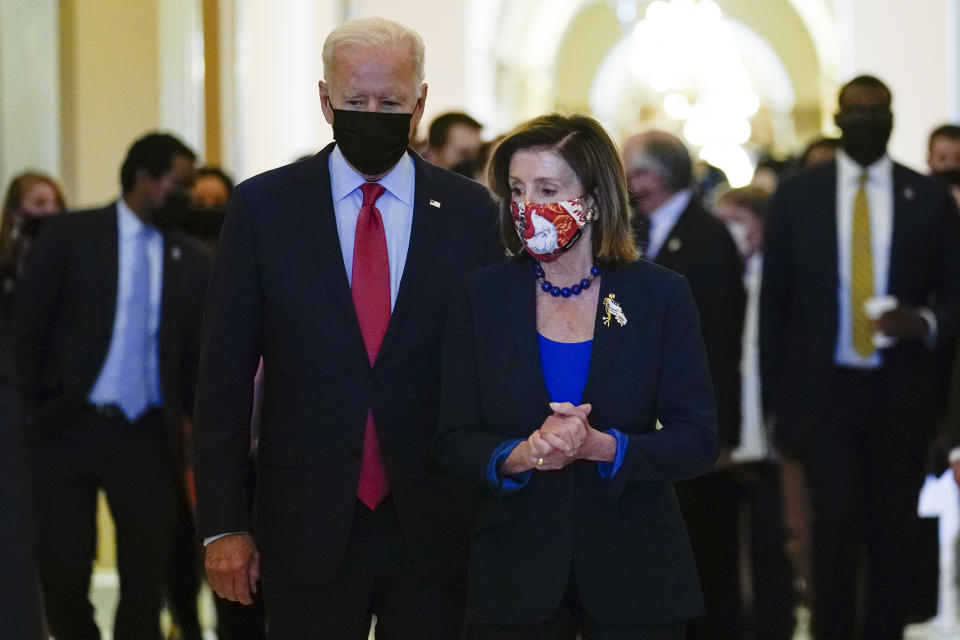 FILE - President Joe Biden walks with House Speaker Nancy Pelosi of Calif., on Capitol Hill in Washington, Friday, Oct. 1, 2021, after attending a meeting with the House Democratic caucus to try to resolve an impasse around the bipartisan infrastructure bill. (AP Photo/Susan Walsh, File)