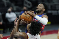 Detroit Pistons guard Josh Jackson and Cleveland Cavaliers guard Collin Sexton battle for control during the second half of an NBA basketball game, Monday, April 19, 2021, in Detroit. (AP Photo/Carlos Osorio)