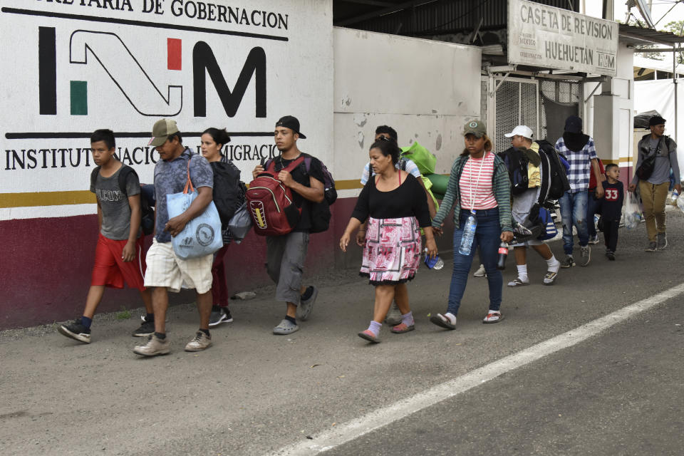 Migrants march to Huehuetan, Chiapas state, Mexico, Monday, April 24, 2023. About 3,000 migrants began walking before dawn for a second day of protest march demanding the end of detention centers like the one that caught fire last month, killing 40 migrants. (AP Photo/Edgar H. Clemente)