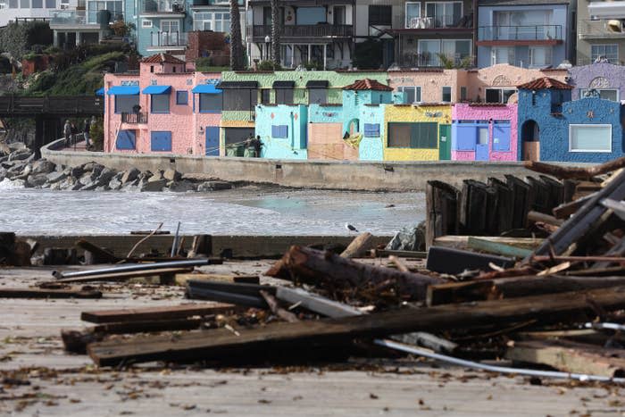 Colorful houses surrounded by debris.