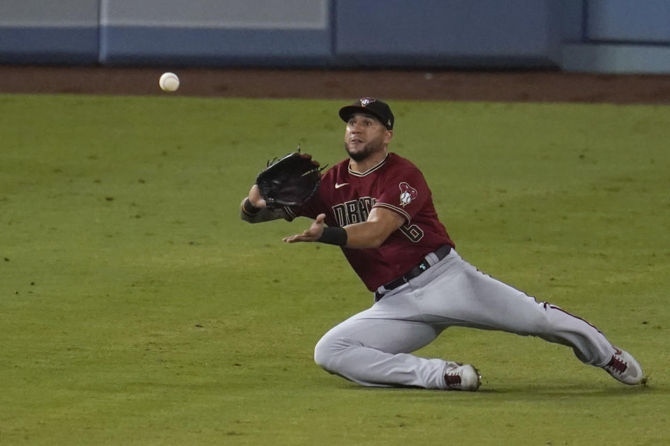 Arizona Diamondbacks left fielder David Peralta makes a sliding catch on a fly ball hit by Los Angeles Dodgers' Edwin Rios during the eighth inning of a baseball game Wednesday, Sept. 2, 2020, in Los Angeles. (AP Photo/Marcio Jose Sanchez)