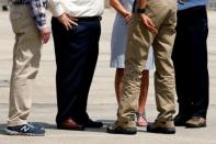 U.S. President Barack Obama (2nd R) and elected officials who greeted him upon arriving aboard Air Force One were all seen wearing comfortable shoes to tour flood-affected areas at Baton Rouge Metropolitan Airport in Baton Rouge, Louisiana, U.S., August 23, 2016. REUTERS/Jonathan Ernst