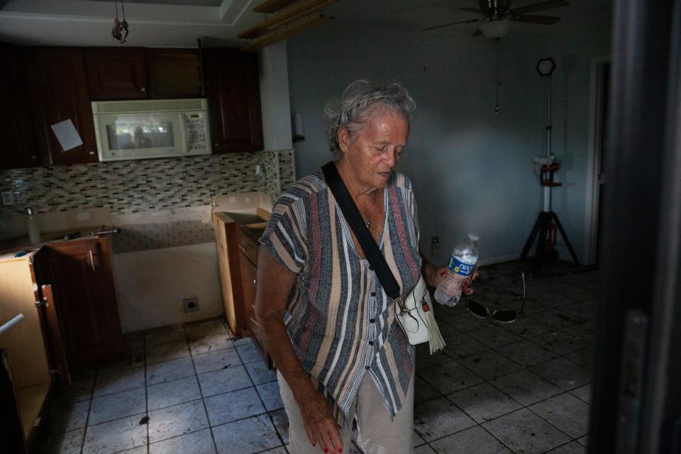 Nancy Kelley shows damage in her home in the Island Park neighborhood of South Fort Myers on Tuesday, Oct. 4, 2022. Her home was flooded and she lost all of her downstairs possessions. The United Cajun Navy was handing out food, water and supplies to people affected by Hurricane Ian.