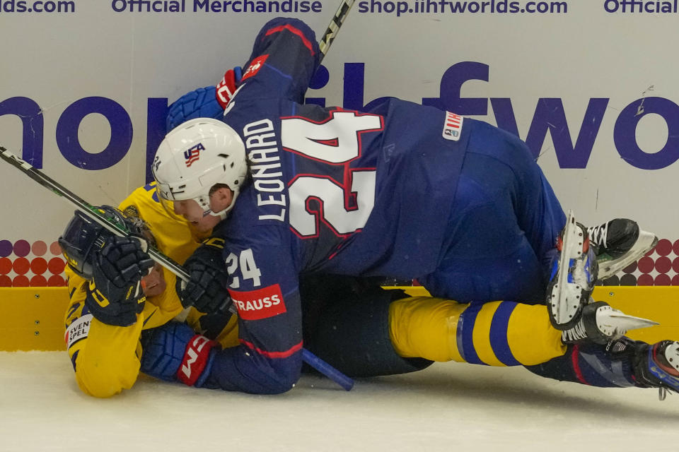 Unted States' Ryan Leonard, top, challenges with Sweden's Jonas Brodin during the preliminary round match between Sweden and United States at the Ice Hockey World Championships in Ostrava, Czech Republic, Friday, May 10, 2024. (AP Photo/Darko Vojinovic)