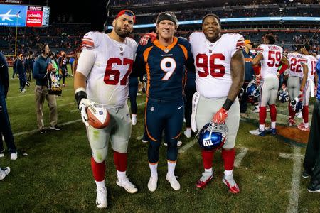 FILE PHOTO: Oct 15, 2017; Denver, CO, USA; Denver Broncos punter Riley Dixon (9) poses for a picture with New York Giants offensive guard Justin Pugh (67) and defensive tackle Jay Bromley (96) after their game at Sports Authority Field at Mile High. Isaiah J. Downing-USA TODAY Sports