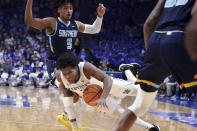 Kentucky's Sahvir Wheeler falls after being fouled by Southern University's P.J. Byrd (3) during the first half of an NCAA college basketball game in Lexington, Ky., Tuesday, Dec. 7, 2021. (AP Photo/James Crisp)