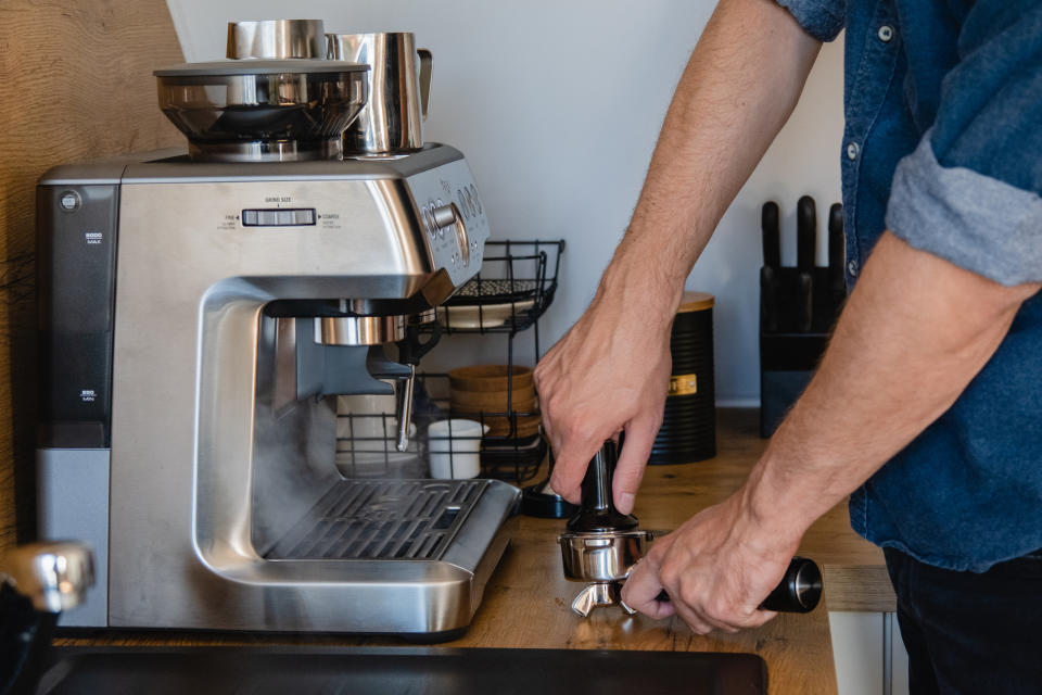 A person using an espresso machine