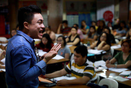 A lecturer teaches Filipino workers, including nurses applying to work in United Kingdom, at a review center for the International English Language Testing System or IELTS in Manila, Philippines, April 2, 2019. Picture taken April 2, 2019. REUTERS/Eloisa Lopez