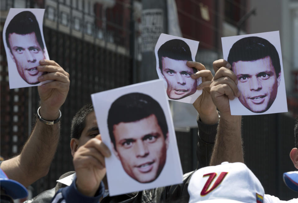 FILE - In this Sept. 12, 2015 file photo, Venezuelan residents and supporters of jailed opposition leader Leopoldo Lopez hold his image as they protest outside Venezuela's embassy in Lima, Peru. Venezuela’s most-famous political prisoner Lopez was arrested in 2014 and later sentenced to nearly 14 years in prison on what are widely seen as trumped-up charges of inciting violence tied to 2014 anti-government protests. (AP Photo/Martin Mejia, File)