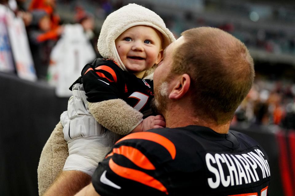 Cincinnati Bengals guard Max Scharping (74) celebrates with his son Brooks after the NFL Week 14 game between the Cincinnati Bengals and the Cleveland Browns at Paycor Stadium in Cincinnati on Sunday, Dec. 11, 2022. The Bengals improved to 9-4 with a 23-10 win over the Browns.
