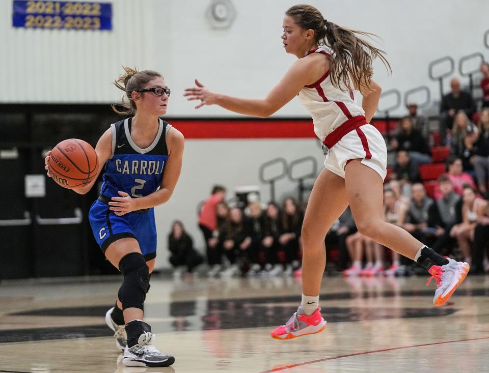 Carroll Cougars Alli Harness (2) passes the ball against Sheridan Blackhawks guard Nova Cross (5) on Thursday, Nov. 9, 2023, during the game at Sheridan High School in Sheridan. The Carroll Cougars defeated the Sheridan Blackhawks, 48-44.