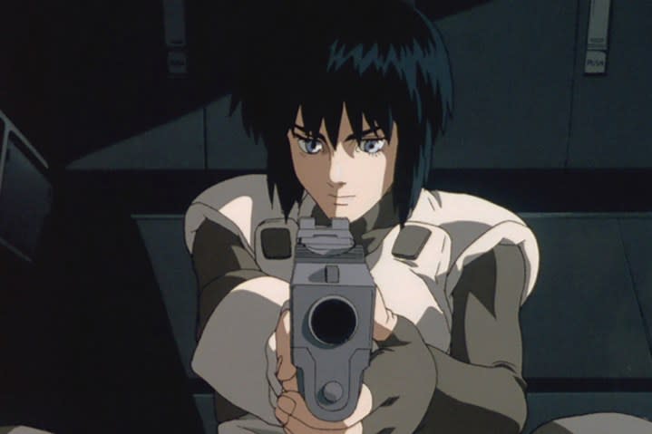 A character points a gun at the camera in Ghost in the Shell.