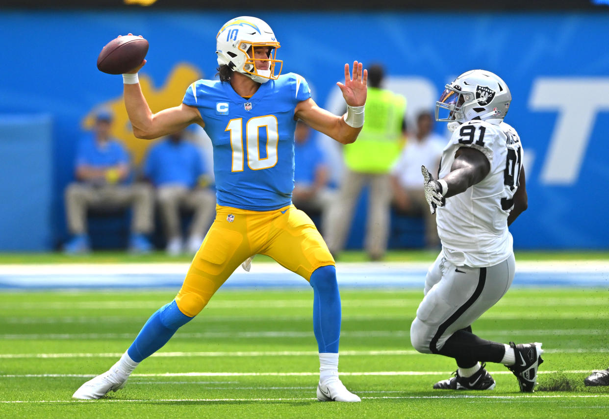 Sep 11, 2022; Inglewood, California, USA; Los Angeles Chargers quarterback Justin Herbert (10) is pressured by Las Vegas Raiders defensive tackle Bilal Nichols (91) as he sets to throw a pass in the first quarter at SoFi Stadium. Mandatory Credit: Jayne Kamin-Oncea-USA TODAY Sports