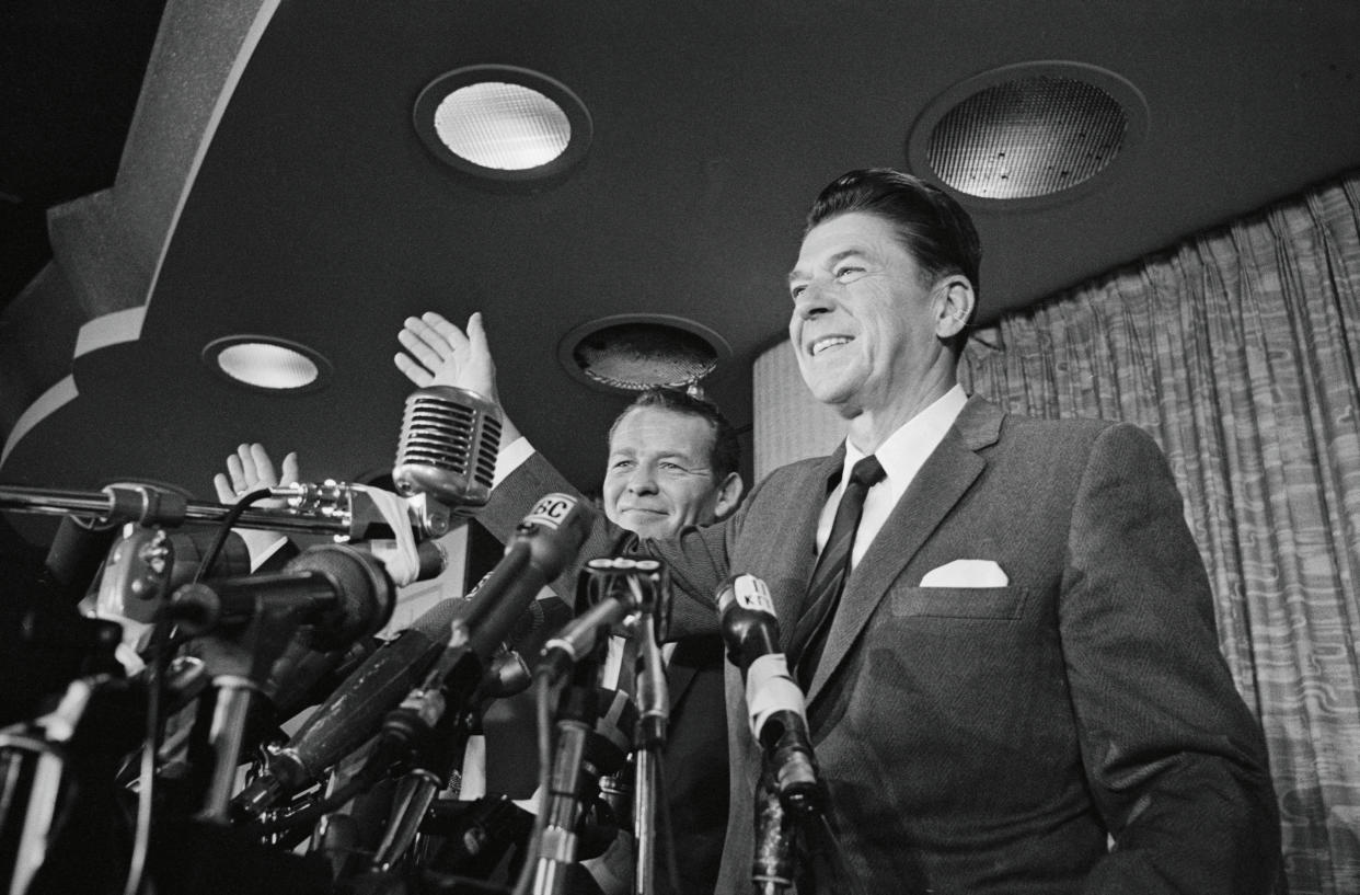 Gov.-elect Ronald Reagan (right) accompanied by Lt. Gov.-elect Robert Finch at their election victory celebration on Nov. 9, 1966. (Bettmann Archive via Getty Images)