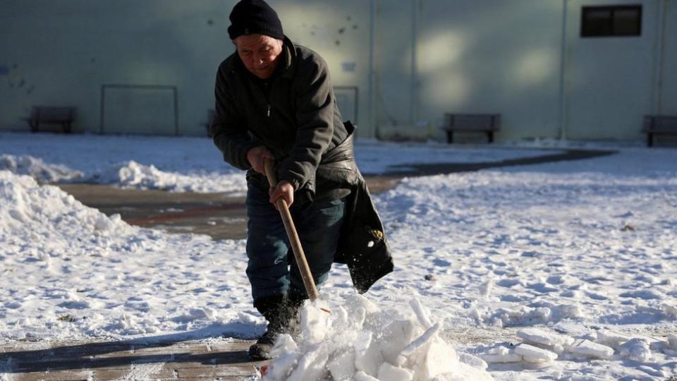 Un hombre quita nieve en un parque en Beijing, China.  Foto: 22 de diciembre de 2023