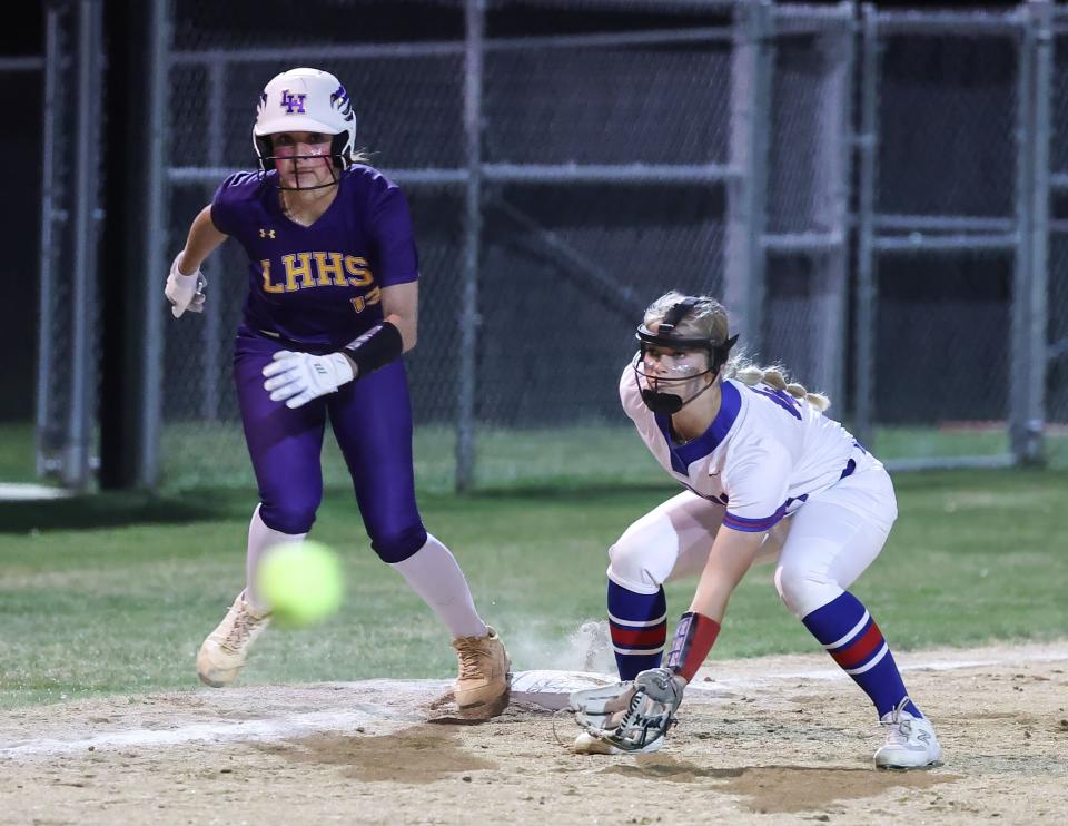 Liberty Hill's Bella Nicholson, left, watches a Leander pitch head toward home plate during a March 9 game at Leander High School. Nicholson, a freshman, homered in last week's repeat matchup, a 10-8 win.