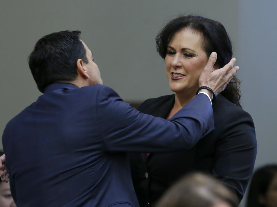 Assemblywoman Lorena Gonzalez, D-San Diego, receives congratulations from Assembly Speaker Anthony Rendon, of Lakewood after her to give new wage and benefit protections at the so-called gig economy companies like Uber and Lyft was approved by the Assembly in Sacramento, Calif., Wednesday, Sept. 11, 2019. The bill now goes to the governor, who has said he supports it. (AP Photo/Rich Pedroncelli)