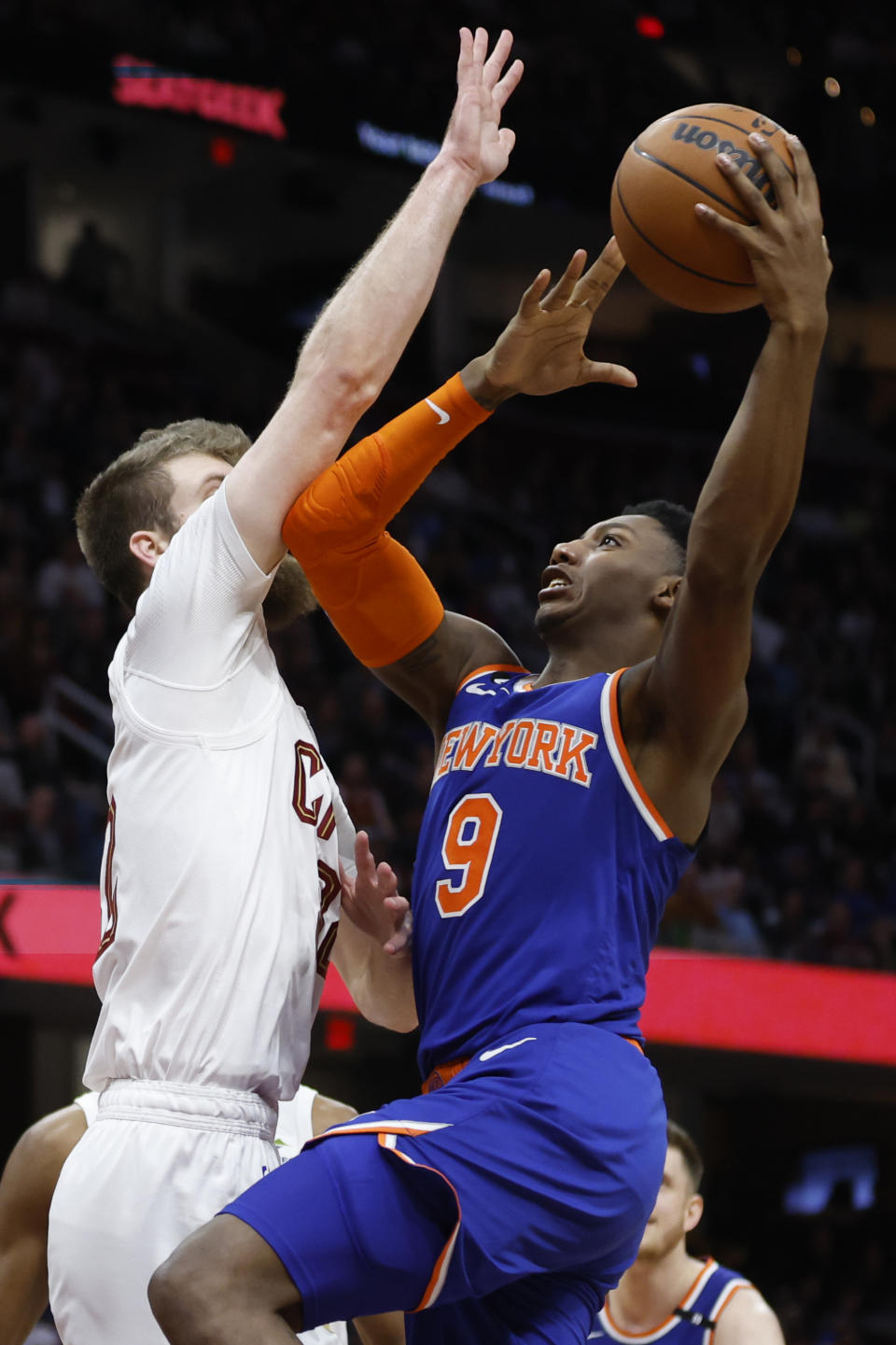 New York Knicks guard RJ Barrett (9) shoots against Cleveland Cavaliers forward Dean Wade during the second half of an NBA basketball game, Friday, March 31, 2023, in Cleveland. (AP Photo/Ron Schwane)