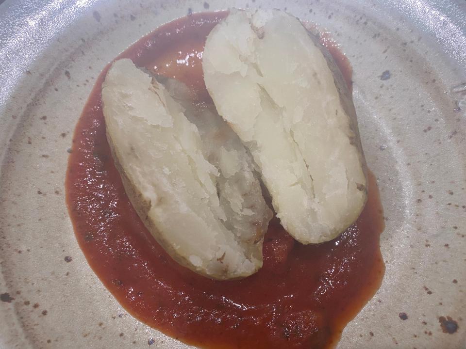 baked potato on a plate with marinara sauce