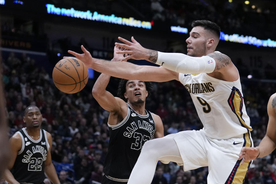 New Orleans Pelicans center Willy Hernangomez (9) battles under the basket against San Antonio Spurs guard Tre Jones (33) in the second half of an NBA basketball game in New Orleans, Thursday, Dec. 22, 2022. The Pelicans won 126-117. (AP Photo/Gerald Herbert)