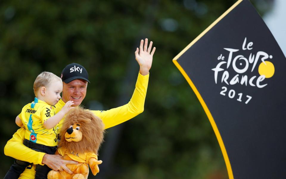 Team Sky rider and yellow jersey Chris Froome of Britain celebrates his overall win with his son Kellan - Credit: Reuters