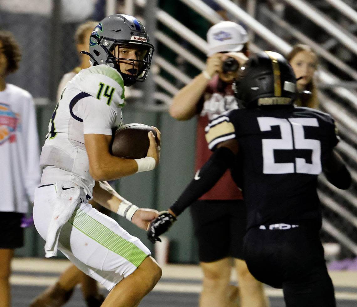 Haslet Eaton quarterback Noah Lugo (14) skirts the sidelines defended by Keller Fossil Ridge defensive back Cameron Smith (25) in the first half of a UIL high school football game at Keller ISD Stadium in Keller, Texas, Thursday, Sept. 21, 2023. Eaton led 24-14 at the half. Bob Booth/Special to the Star-Telegram