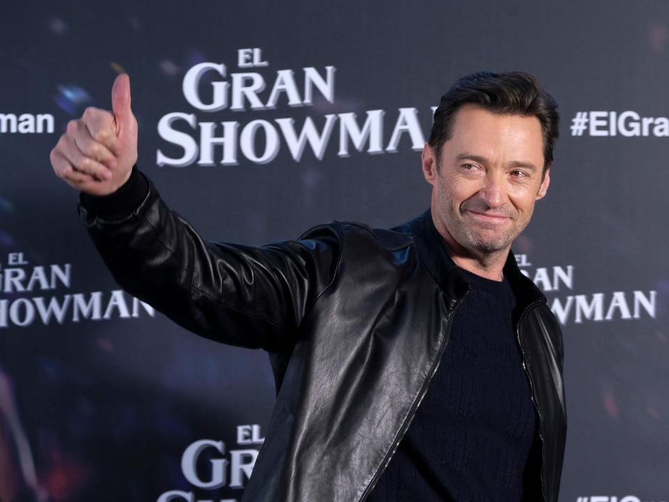 Hugh Jackman gives a thumbs-up on the red carpet for The Greatest Showman