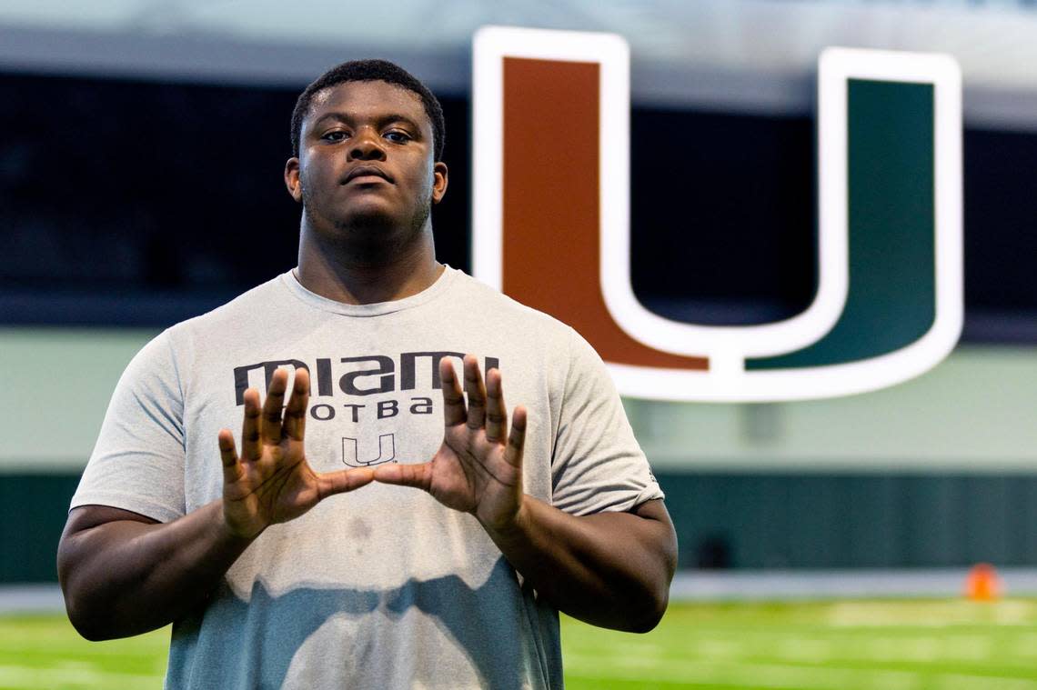 Miami Hurricanes offensive lineman Javion Cohen throws up the U for a portrait after spring football practice at the University of Miami’s Greentree Practice Field in Coral Gables, Florida, on Tuesday, March 28, 2023.