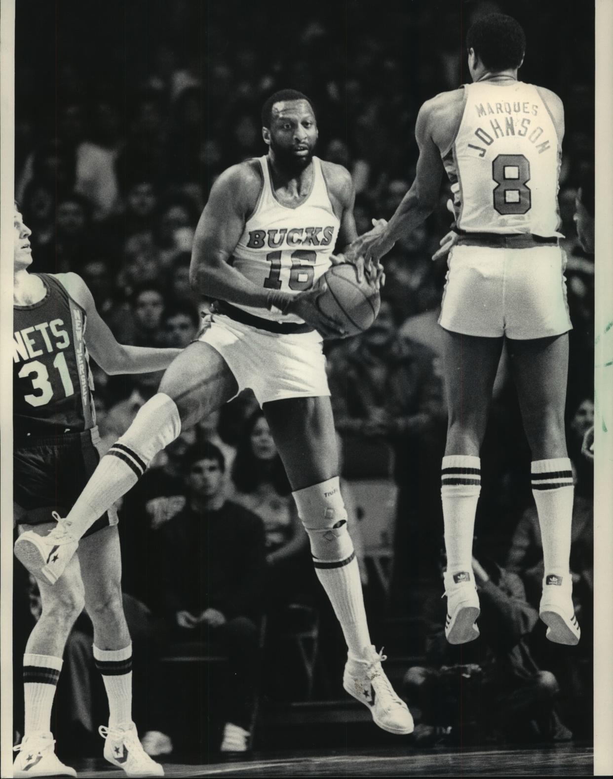 Bob Lanier of the Milwaukee Bucks and teammate Marques Johnson went in the air to secure a rebound during Sunday's NBA playoff game against the New Jersey at the Arena.