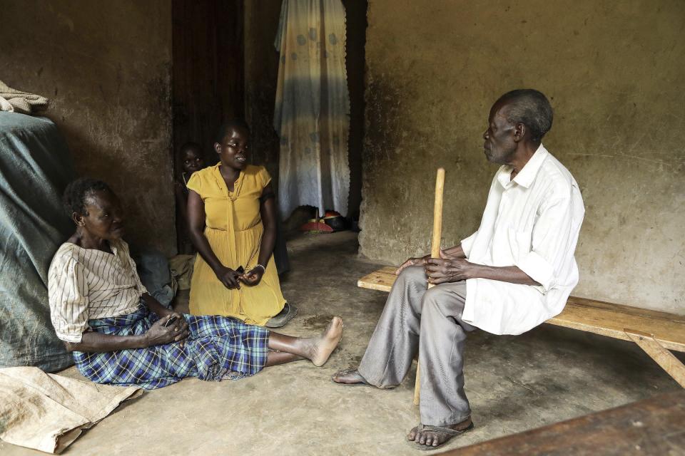 Barbara Nabulo interacts with her parents at Kilombe village, in Mbale, Uganda, Friday, April. 26, 2024. There can be lifelong challenges for people with sickle cell disease in rural Uganda, where it remains poorly understood. (AP Photo/Hajarah Nalwadda)