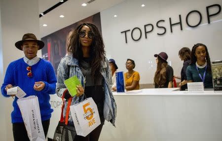 Shoppers check out during British clothing retailer Topshop's grand opening of the chain's New York flagship store, November 5, 2014. REUTERS/Brendan McDermid