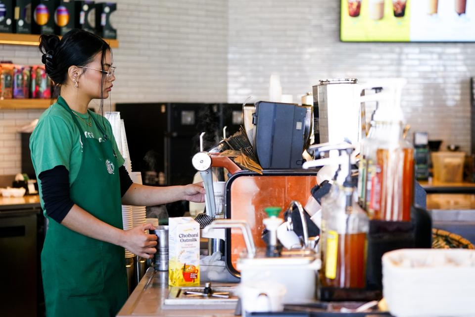 File - Nicole Lipa prepares a drink at a Starbucks location, June 28, 2023, in Seattle. On Friday, the U.S. government issues its November jobs report. (AP Photo/Lindsey Wasson, File)