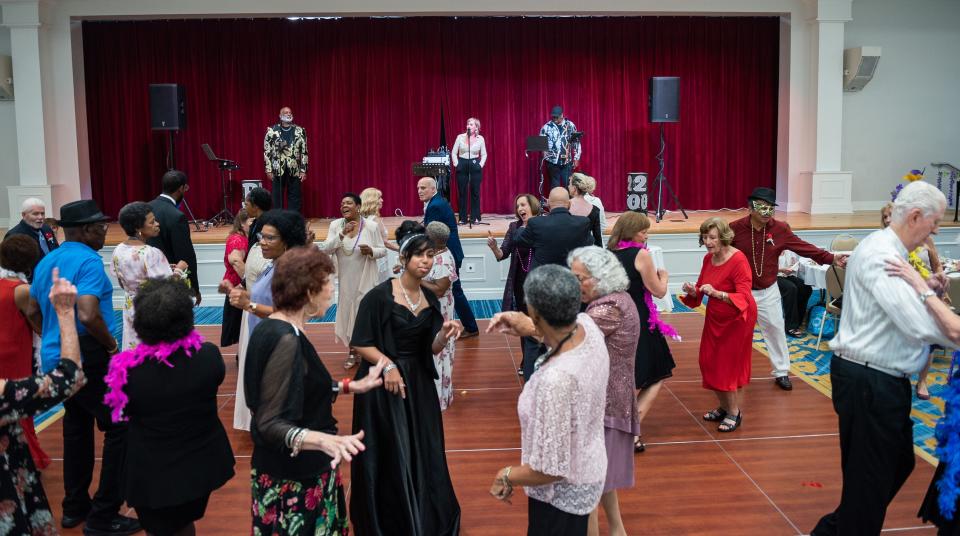 About two dozen guests dance to a live singer during a 'Young At Heart' prom for seniors held at the the Royal Palm Beach Cultural Center on Friday, May 26, 2023, in Royal Palm Beach, Fla.