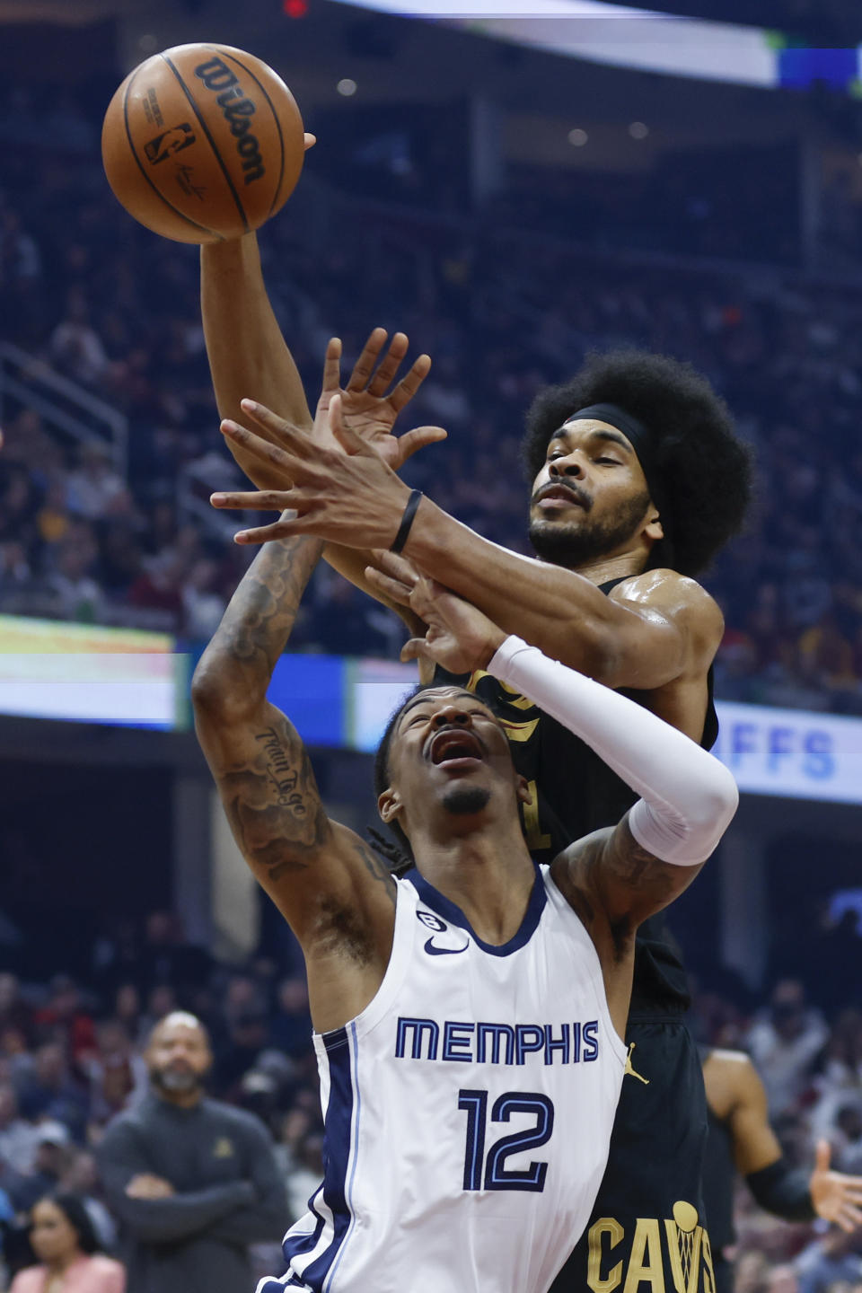 Cleveland Cavaliers center Jarrett Allen blocks a shot by Memphis Grizzlies guard Ja Morant (12) during the first half of an NBA basketball game, Thursday, Feb. 2, 2023, in Cleveland. (AP Photo/Ron Schwane)