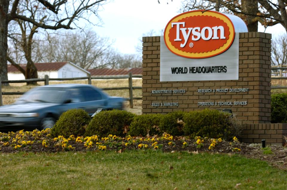 A car passes in front of a Tyson Foods Inc., sign at Tyson headquarters in Springdale, Ark.